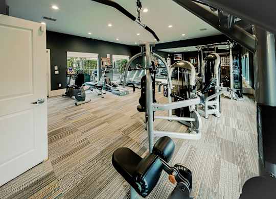 A gym with a variety of equipment including weights and cardio machines. at Legends at Rancho Belago, Moreno Valley, California