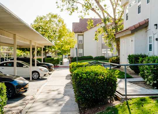 A row of parked cars in front of a building. at Legends at Rancho Belago, California