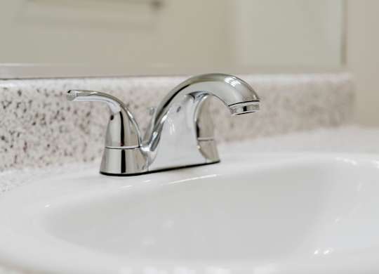 A white sink with a chrome faucet. at Legends at Rancho Belago, Moreno Valley, 92553