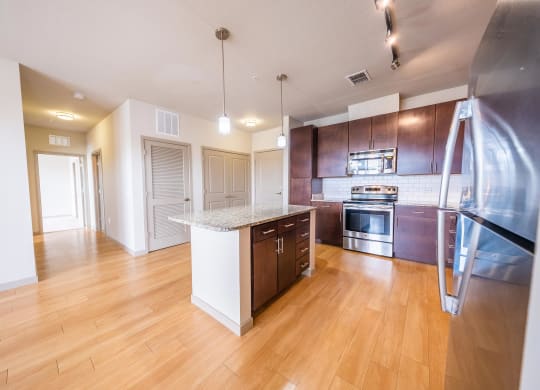 a kitchen with wood flooring and stainless steel appliances at Azul Baldwin Park, Orlando, FL, 32814