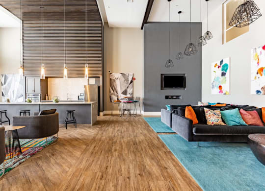 a living room with a couch and a kitchen at Linden on the GreeneWay, Florida, 32824
