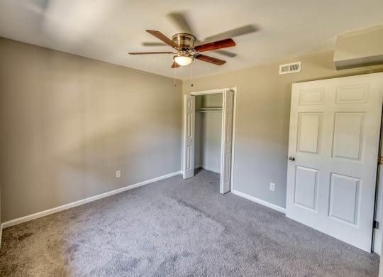 a bedroom with carpet and a ceiling fan at Ashford Place Apartments, North Carolina, 28081