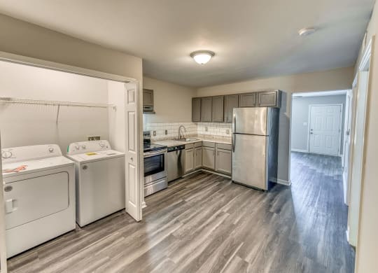 a kitchen with white appliances and stainless steel appliances at Ashford Place Apartments, North Carolina, 28081