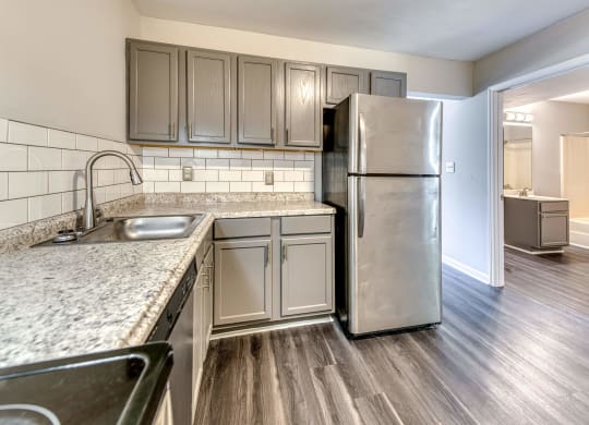 an empty kitchen with a stainless steel refrigerator at Ashford Place Apartments, Kannapolis, 28081