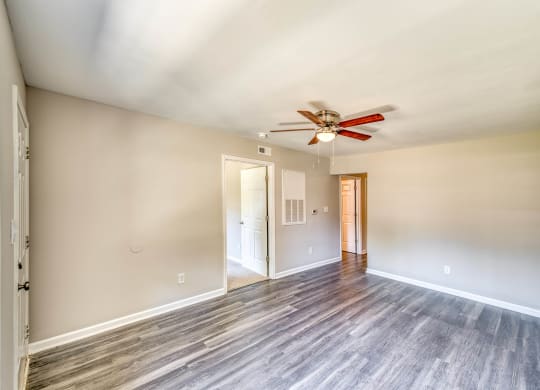 a living room with wood floors and a ceiling fan at Ashford Place Apartments, Kannapolis, NC 28081