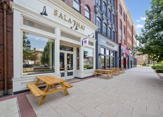 a sidewalk with picnic tables outside of a building at Park Kennedy, Washington