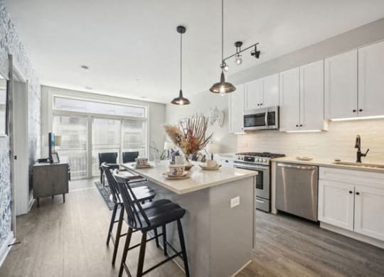a kitchen with a large island and chairs in it at Park Kennedy, Washington, DC