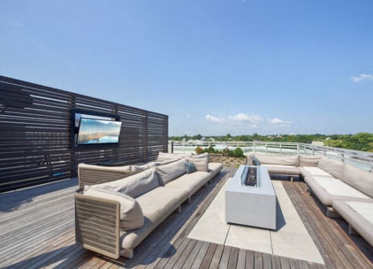 a patio with couches and a table on a roof at Park Kennedy, Washington, DC