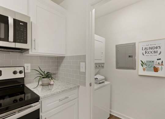 a kitchen with white cabinets and a stove and a microwave