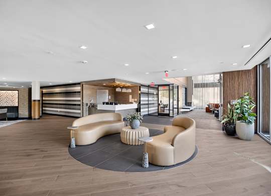 A modern living room with a curved sofa and a coffee table.