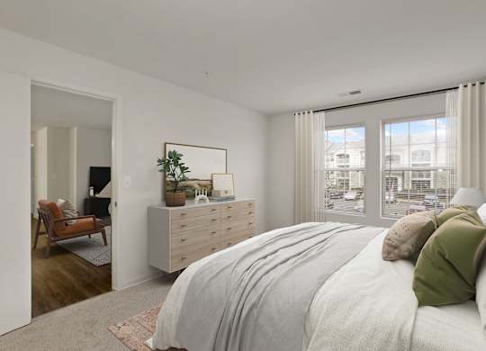 a bedroom with a bed and a dresser and a window at The Fields of Manassas