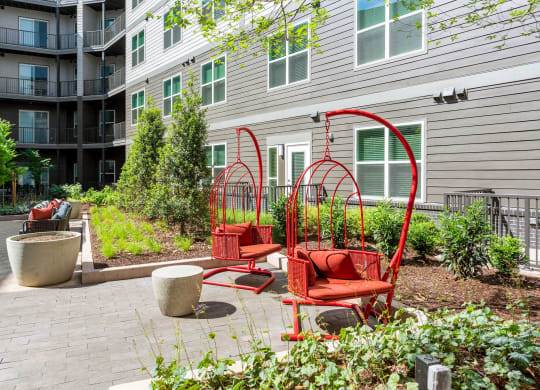 a group of red chairs sitting in front of a building at Vyne One Loudoun, Ashburn, VA, 20147