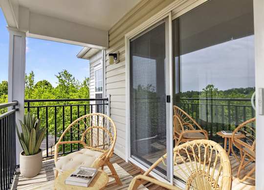 A balcony with a chair and a table.