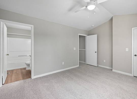 A spacious room with a ceiling fan and carpeted floor. at Greens at Stonecreek, Lithonia, GA, 30038