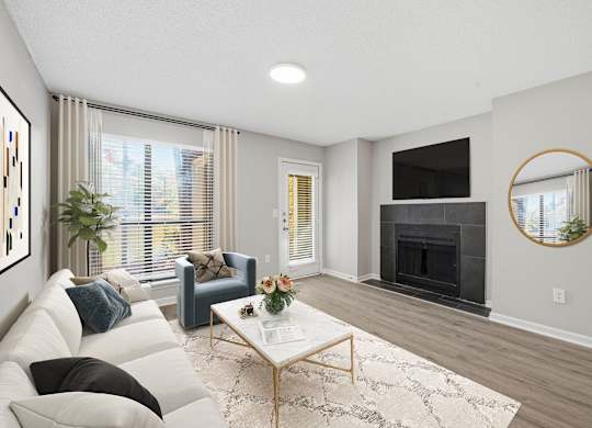 A living room with a white couch, a coffee table, and a fireplace at Brampton Moors, Cary, NC, 27513