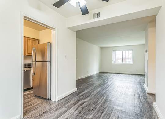 A kitchen with a refrigerator and a window.