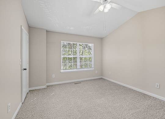 Empty room with a window and a ceiling fan. at Greens at Stonecreek, Lithonia, GA