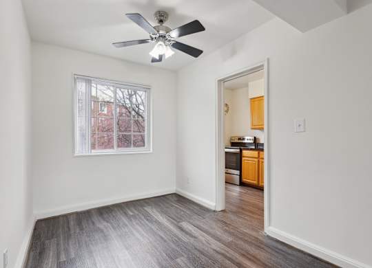 A room with a ceiling fan and a window.