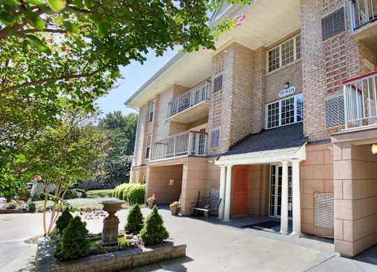 A building with a balcony and a fountain in front of it at Shenandoah Station Apartments, Triangle, VA, 22172