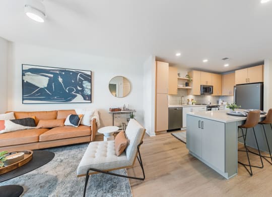 a living room with a couch and a kitchen with a counter at Hawkins Press, Charlotte, NC