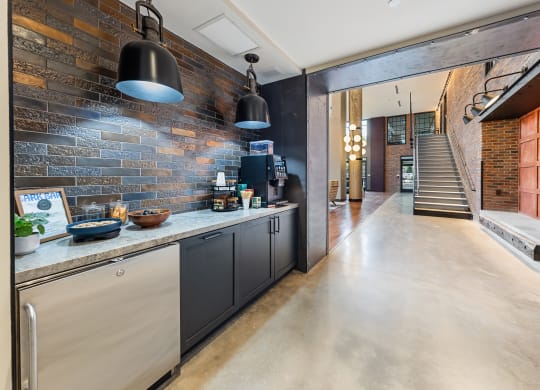 a kitchen with a counter top and a brick wall at Hawkins Press, Charlotte