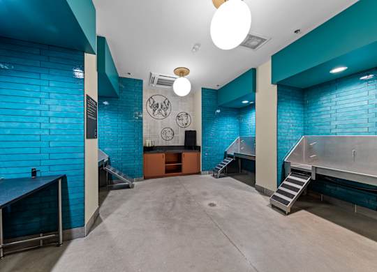 A room with a blue tiled wall and a concrete floor at Hawkins Press Apartments, Charlotte