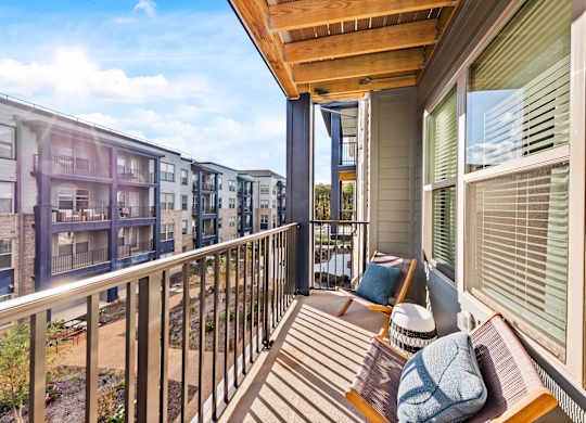 A balcony with a bench and pillow on it.
