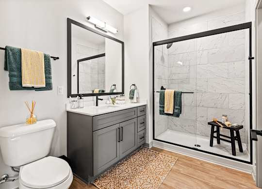 A bathroom with a white toilet and a white sink.