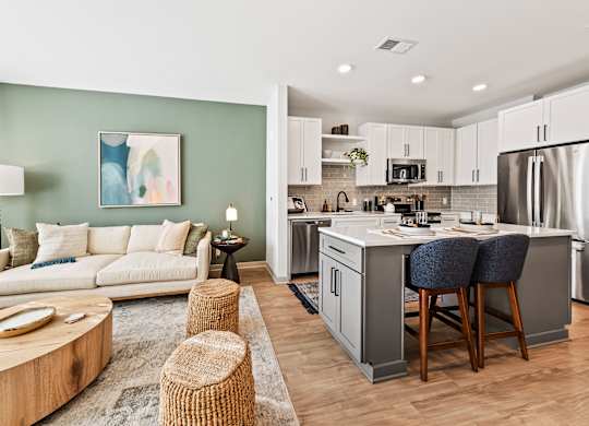 A modern kitchen with a breakfast bar and a living room area.