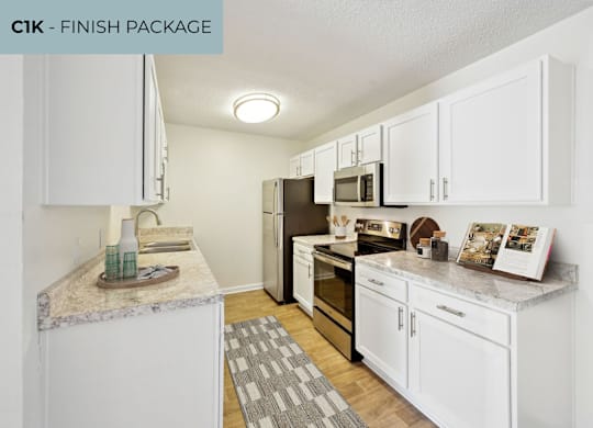 A kitchen with white cabinets and a granite countertop.