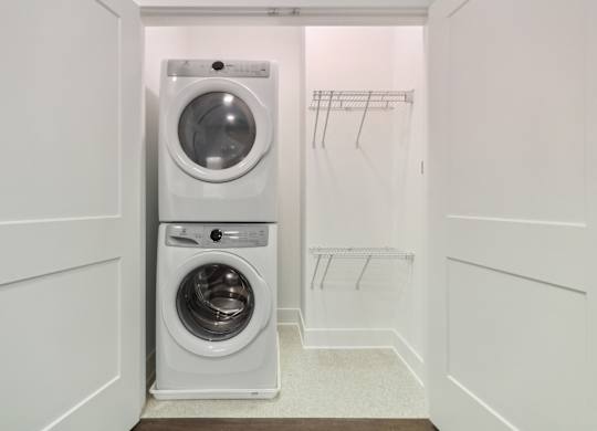 A white laundry room with a washer and dryer. at The Sully, Chantilly, VA, 20151