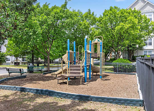 A playground with a slide and a wooden structure.