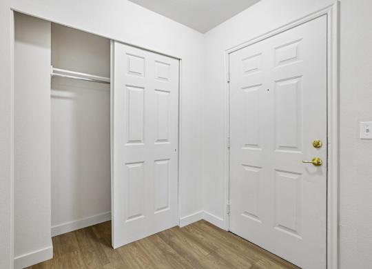 A white door with a gold handle is on the right.