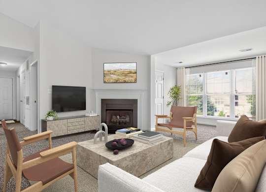 A living room with a fireplace, a television, and a painting on the wall.