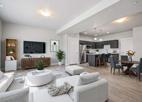 A modern living room with a white sofa set and a wooden entertainment center.