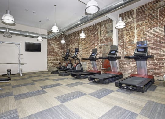 the gym at the district flats apartments in lenexa at The Gunther, Baltimore, MD