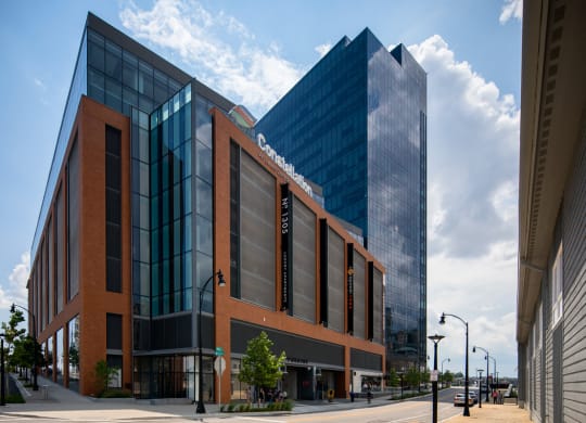 a large brick building with a glass building behind it on a street at 1305 Dock Street, Maryland
