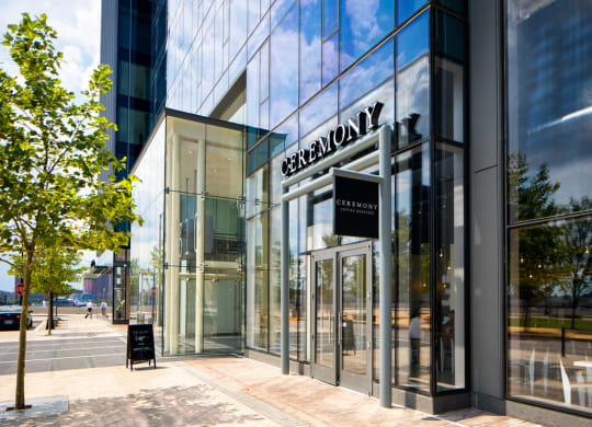 a view of the front of a glass building with a sign on the side at 1305 Dock Street, Baltimore