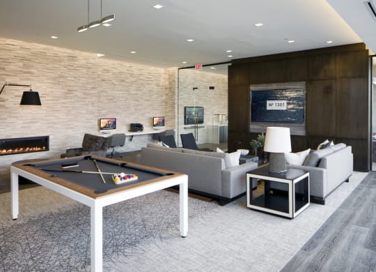 a living room with a pool table and a fireplace at 1305 Dock Street, Baltimore, MD