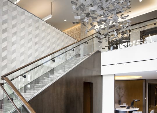 a staircase in the lobby of a building with a large glass chandelier at 1305 Dock Street, Maryland, 21231