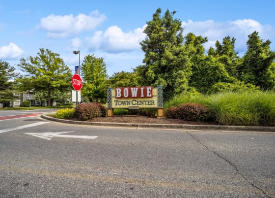 a stop sign in front of a sign for bowie town center at Fairmont at South Lake, Bowie, MD