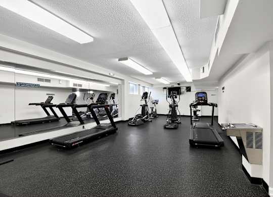 A gym with treadmills, elliptical machines, and other exercise equipment at Avondale Overlook, Hyattsville, 20782