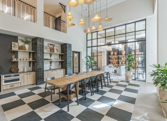 a dining room with a long wooden table and chairs in front of a large window  at La Unión, Tampa, 33605