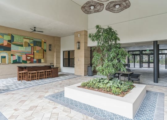 a lobby with a garden and a painting on the wall  at La Unión, Tampa, FL