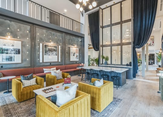 a lobby with couches and tables and large windows at La Unión, Tampa, FL 33605
