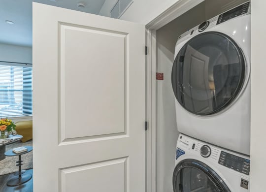 a laundry room with a washer and dryer next to a white door  at La Unión, Florida, 33605