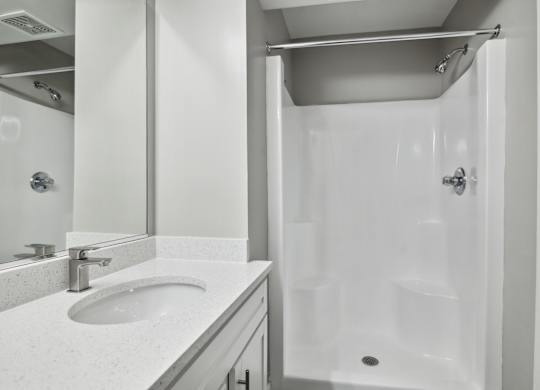 A white bathroom with a sink and a shower at Shenandoah Station Apartments, Triangle, Virginia