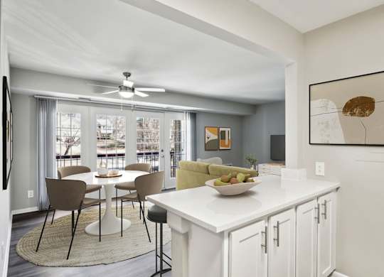 A modern kitchen with a dining table and chairs.