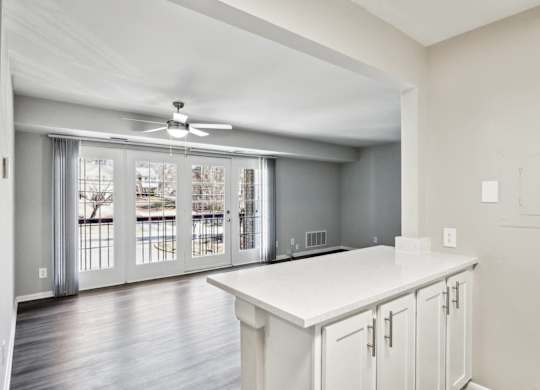 A kitchen with white cabinets and a ceiling fan at Shenandoah Station Apartments, Triangle, VA, 22172