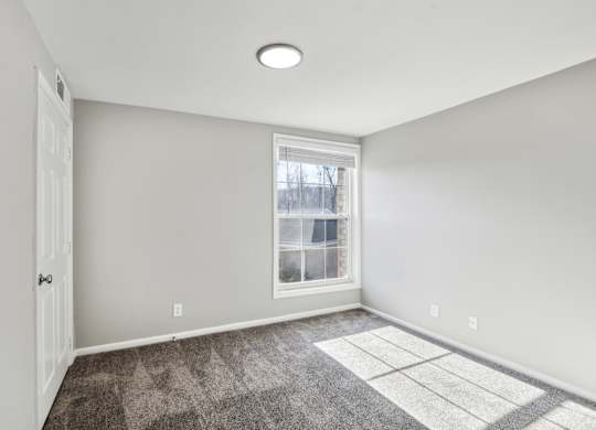 A room with a window and a rug on the floor at Shenandoah Station Apartments, Triangle, VA, 22172